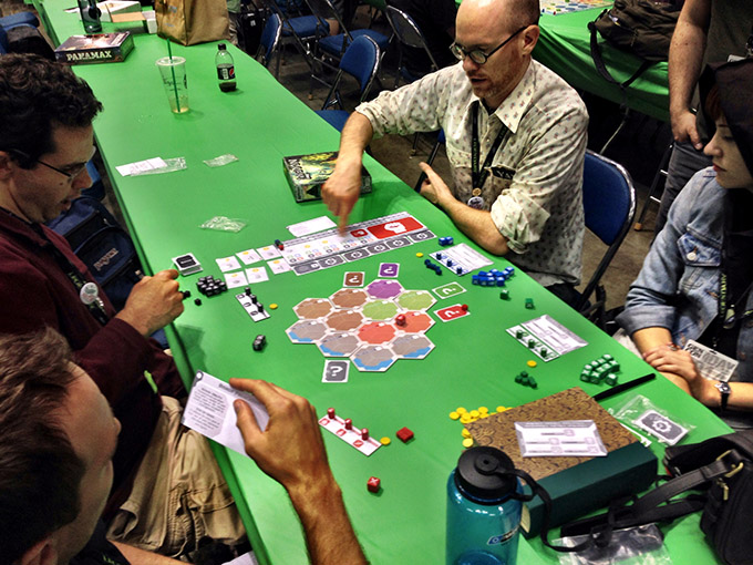 As is our custom, we all gathered in Hall D after hours to play unpublished prototypes in our impromptu Unpub area. Here we see David Chott, Ben Rosset and company playing Adam McIver's upcoming Kingdom Land.